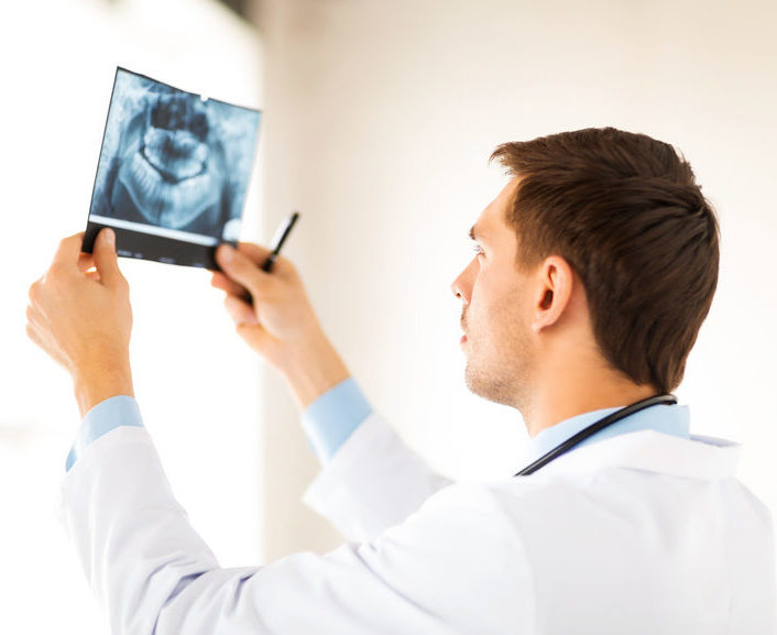 Dentist Looking At An X-Ray